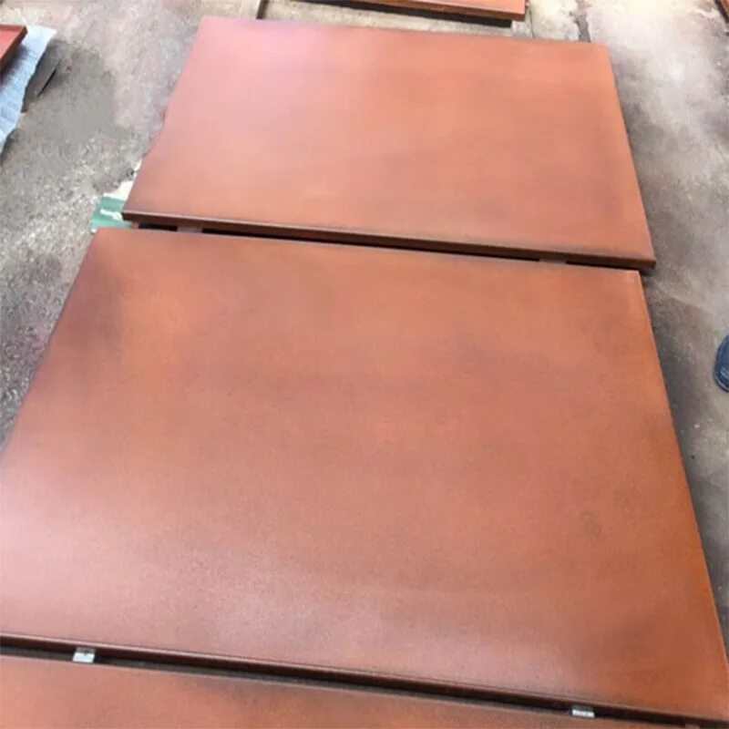 Rust-coloured rectangular steel plates stacked on supports