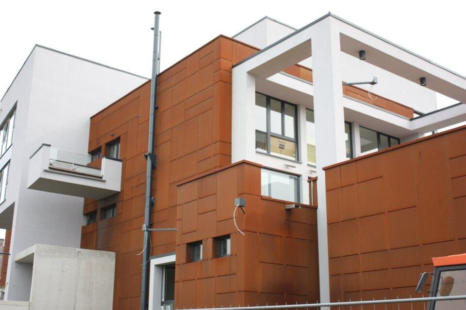 Real weathering steel panel façade with white architectural volumes